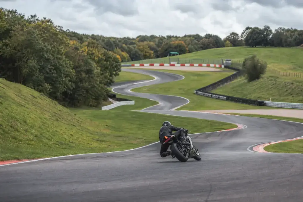 Motorcycle rider negotiating a fast flowing British race circuit
